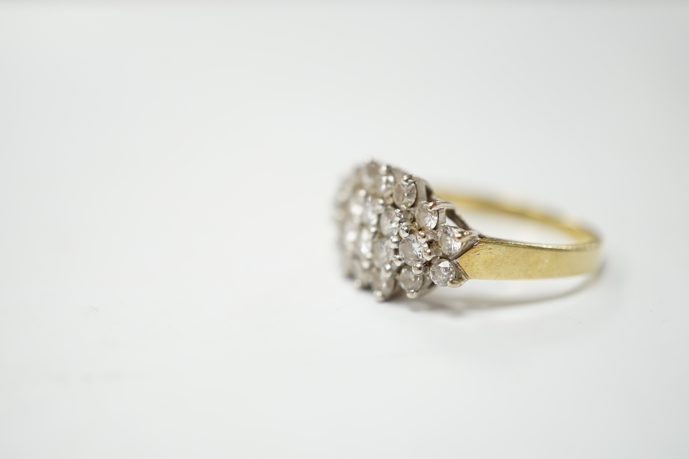 A modern 18ct gold and diamond cluster set dress ring, size P, gross weight 4.4 grams.